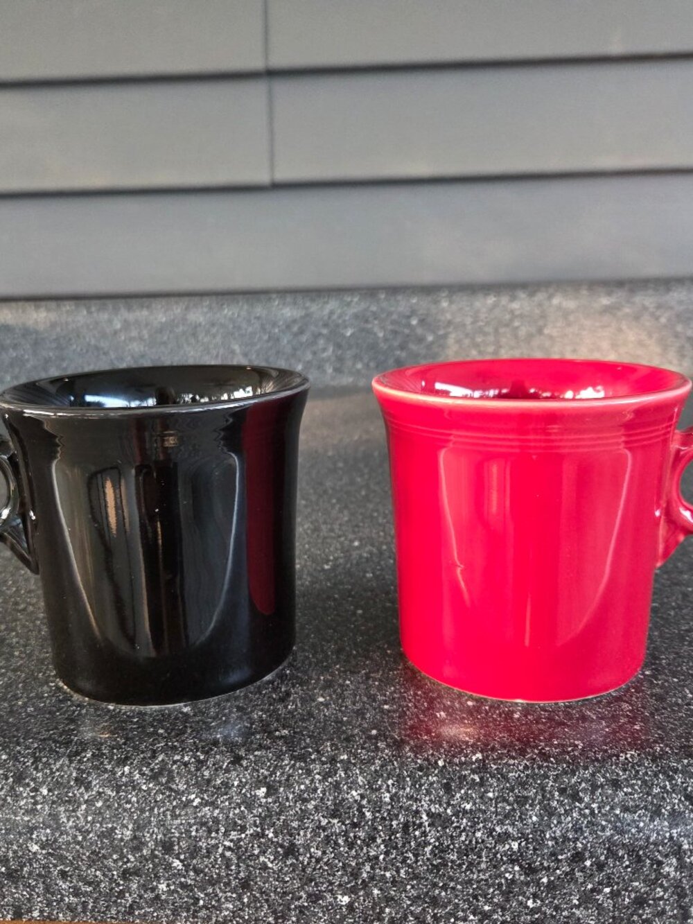 Fiestaware ceramic mugs in black and red with a ring handle, 10.25 oz capacity.
